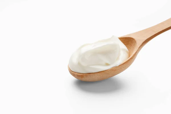 Fresh cream in wooden spoon — Stock Photo, Image