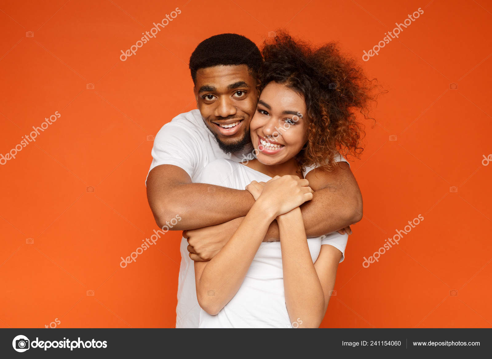 Young lovely african-american couple posing on orange background Stock  Photo by ©Milkos 241154060