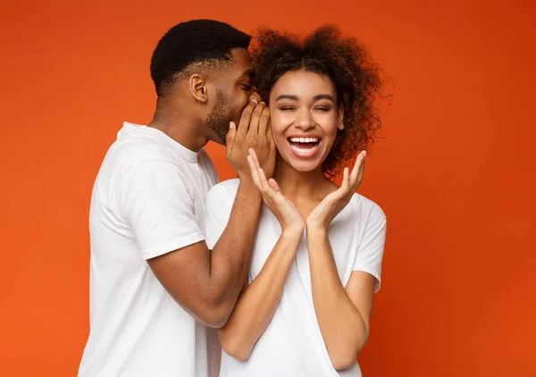 Homem negro compartilhando segredo com sua namorada — Fotografia de Stock