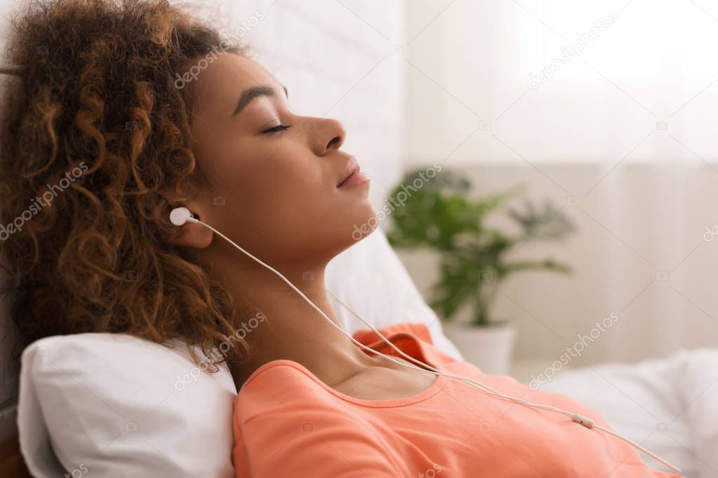 African-american woman listening calm music and relaxing