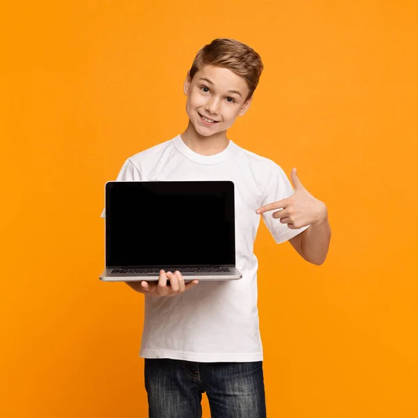 Glücklich lächelnder Junge zeigt auf Laptop-Computer — Stockfoto