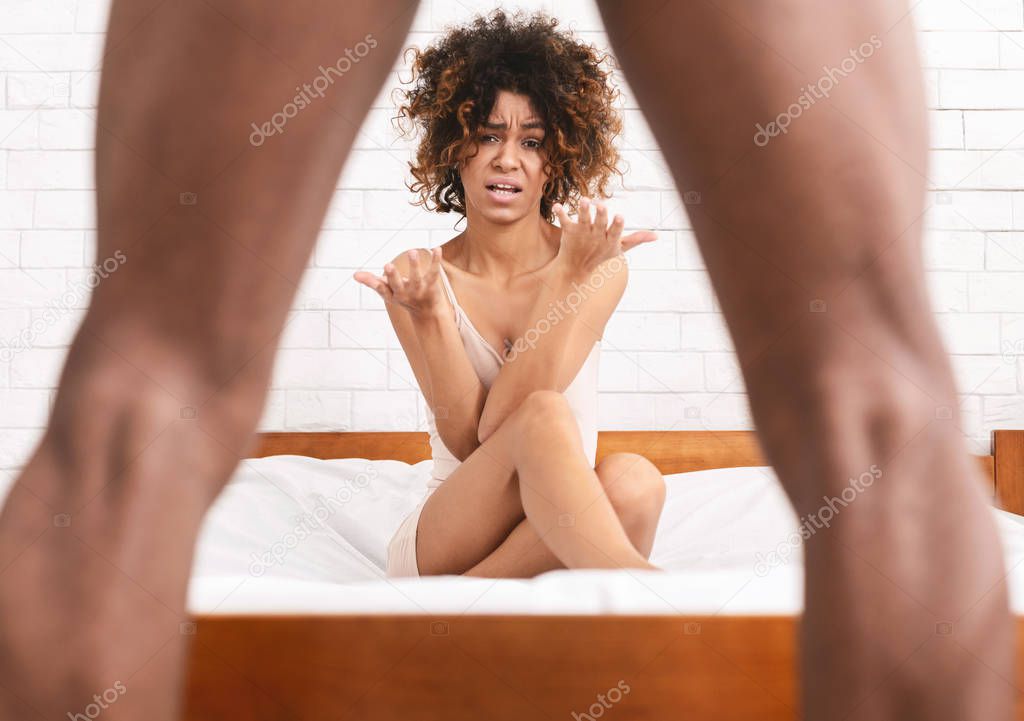 Woman in disbelief looking whats between mans legs