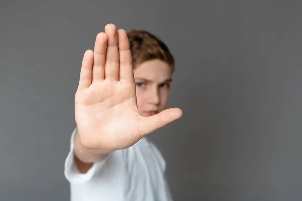 Boy showing stop gesture with his hand — Stock Photo, Image