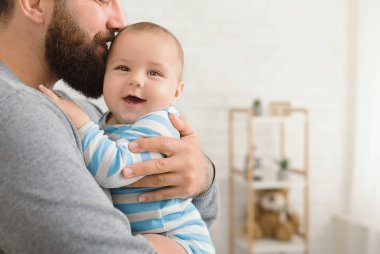 Sevgi dolu babası şirin bebek oğlu kucaklayan