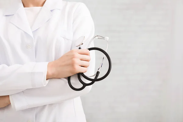 Doctor in white coat holding stethoscope in his hand — Stock Photo, Image