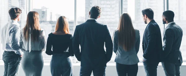 Business colleagues looking through window, back view — Stock Photo, Image