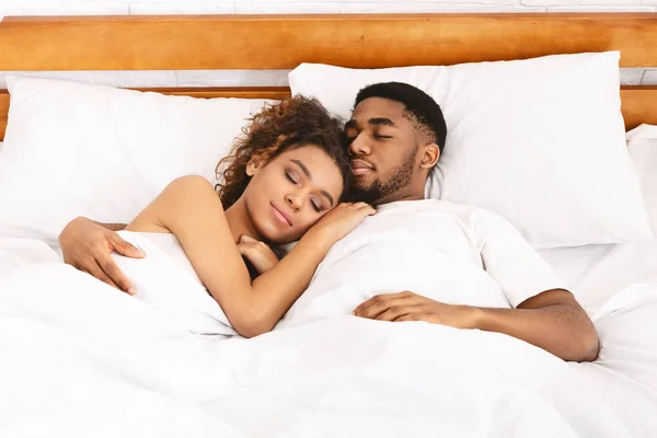 Loving couple sleeping in bed and hugging — Stock Photo, Image