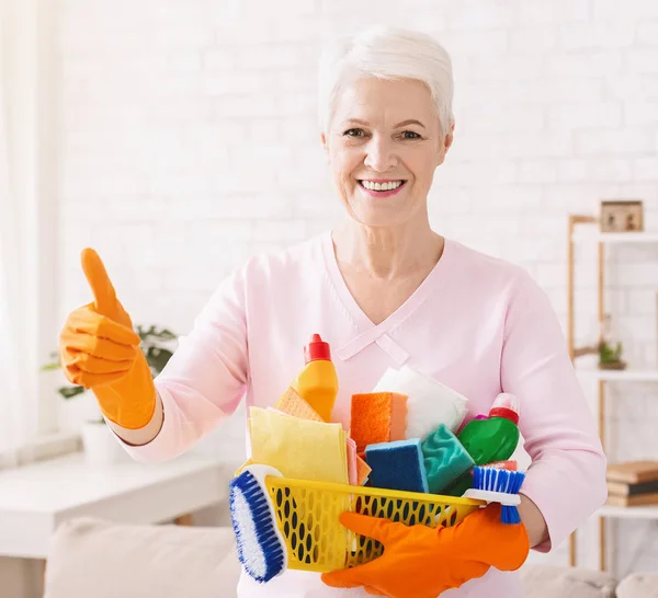 Rijpe huisvrouw schoonmaak vloer thuis glimlachen — Stockfoto