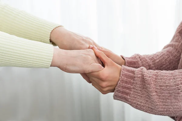 Family support. Senior woman and daughter holding hands — Stock Photo, Image