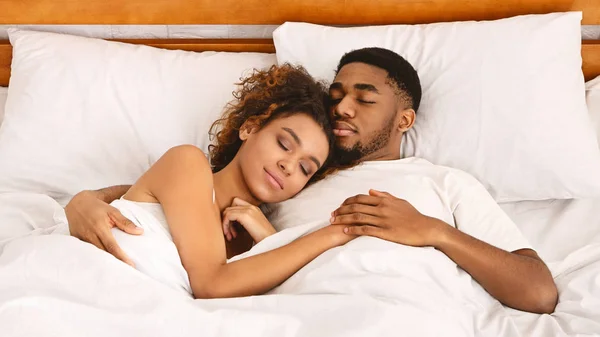Loving couple sleeping in bed and hugging — Stock Photo, Image