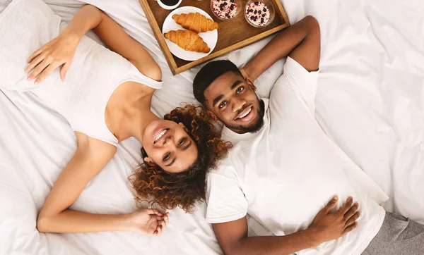 ベッドで健康的な朝食を楽しんでいるアフリカ系アメリカ人のカップル — ストック写真