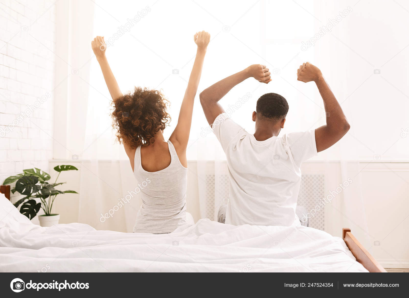 Funny Married Couple Stretching In Bedroom After Wakeup