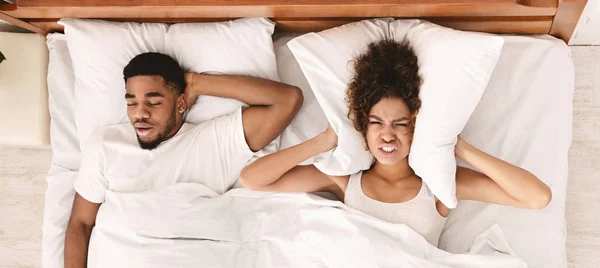 Tired and annoyed woman of her boyfriend snoring — Stock Photo, Image
