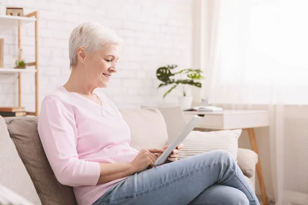 S úsměvem krásná starší žena pomocí digitálních tabletu — Stock fotografie