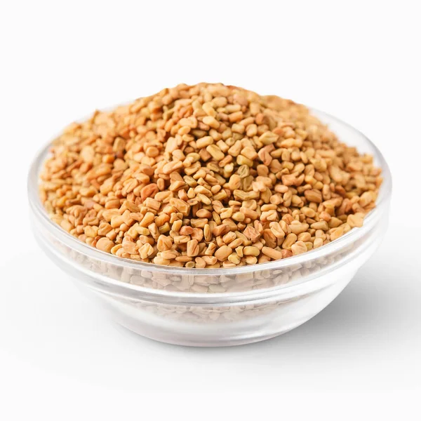 Bowl of aromatic fenugreek seeds isolated on white — Stock Photo, Image