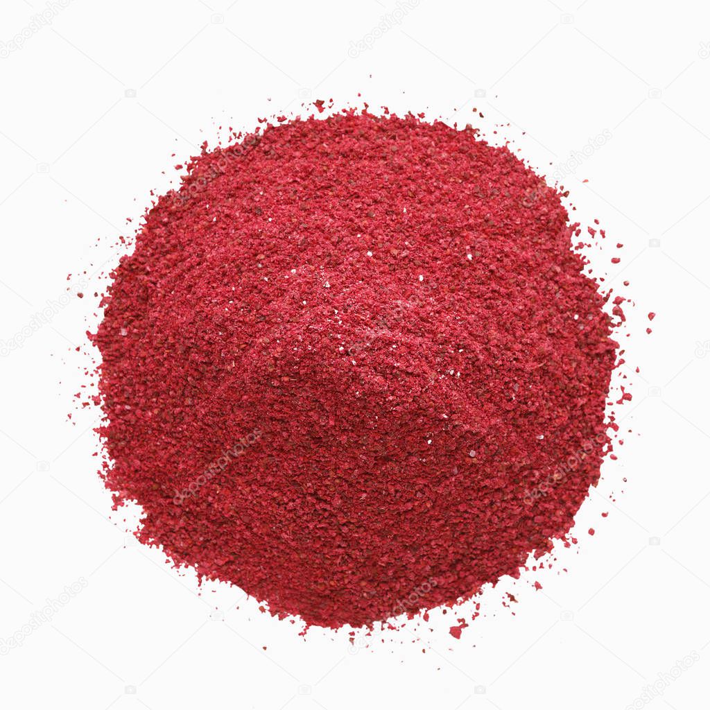 Heap of sumac powder spice isolated on white