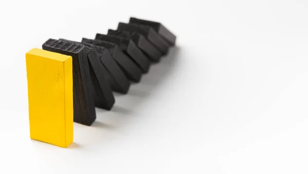 Domino effect stopped by unique strong piece — Stock Photo, Image