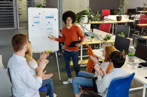 Businesswoman presenting to colleagues at a meeting