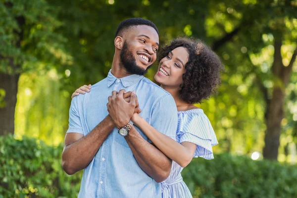 Loving african-american couple hugging in summer park — Stock Photo, Image