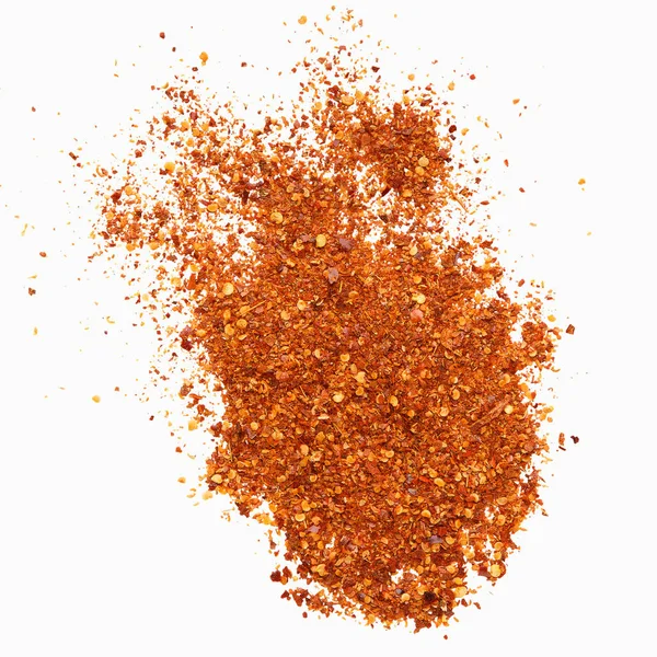 Chili pepper condiment explosion on white background