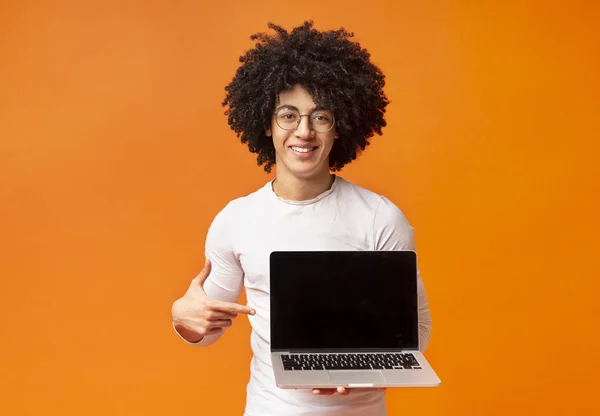 Sorrindo hipster apontando dedo na tela do laptop em branco — Fotografia de Stock