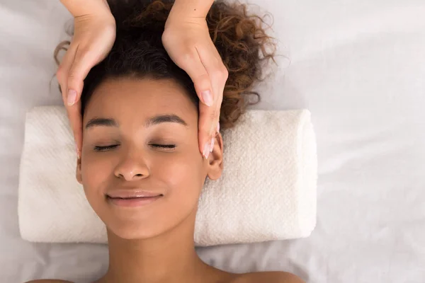 Face treatment. Woman getting facial massage, top view — Stock Photo, Image