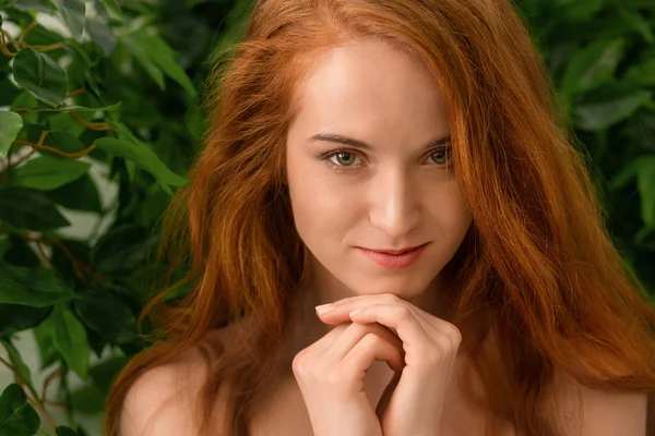 Sensual nude redhead woman looking at camera