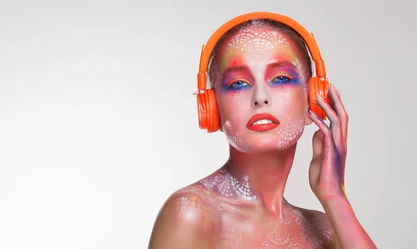 Bright beautiful woman DJ in orange headphones — Stock Photo, Image
