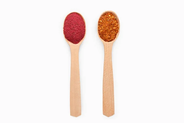 Wooden spoons with chili pepper and sumac on white — Stock Photo, Image