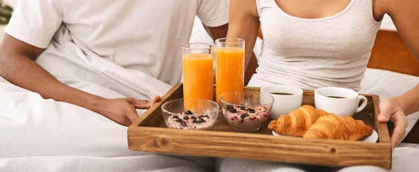 Feliz casal preto desfrutando de café da manhã na cama — Fotografia de Stock