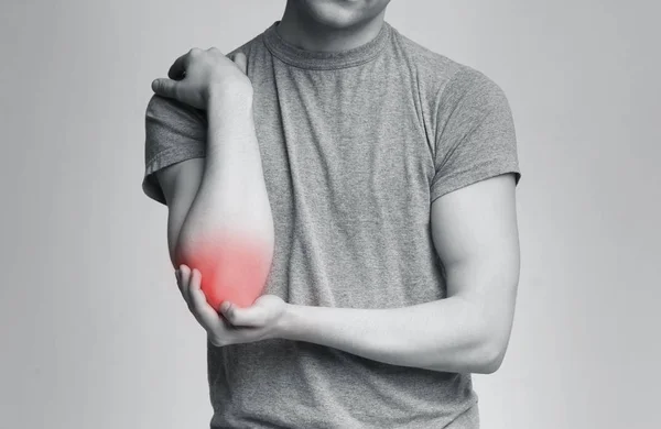 Cropped young man suffering from painful elbow — Stock Photo, Image