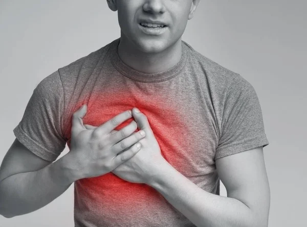 Νεαρός άνδρας έχοντας καρδιακή προσβολή. έννοια της υγειονομικής περίθαλψης — Φωτογραφία Αρχείου