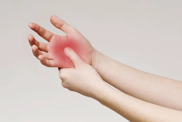 Frau massiert Hand, um Handschmerzen zu stoppen — Stockfoto