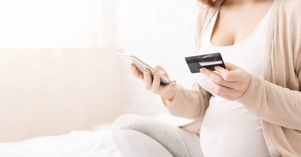 妊娠中の女性がスマート フォンとクレジット カードとオンライン ショッピング — ストック写真