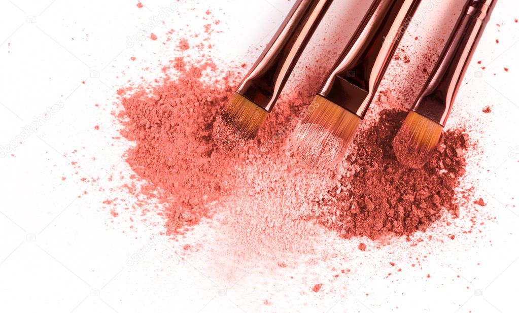 Smears of crushed pink blusher with brushes