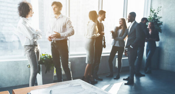 Business colleagues talking, having break in office