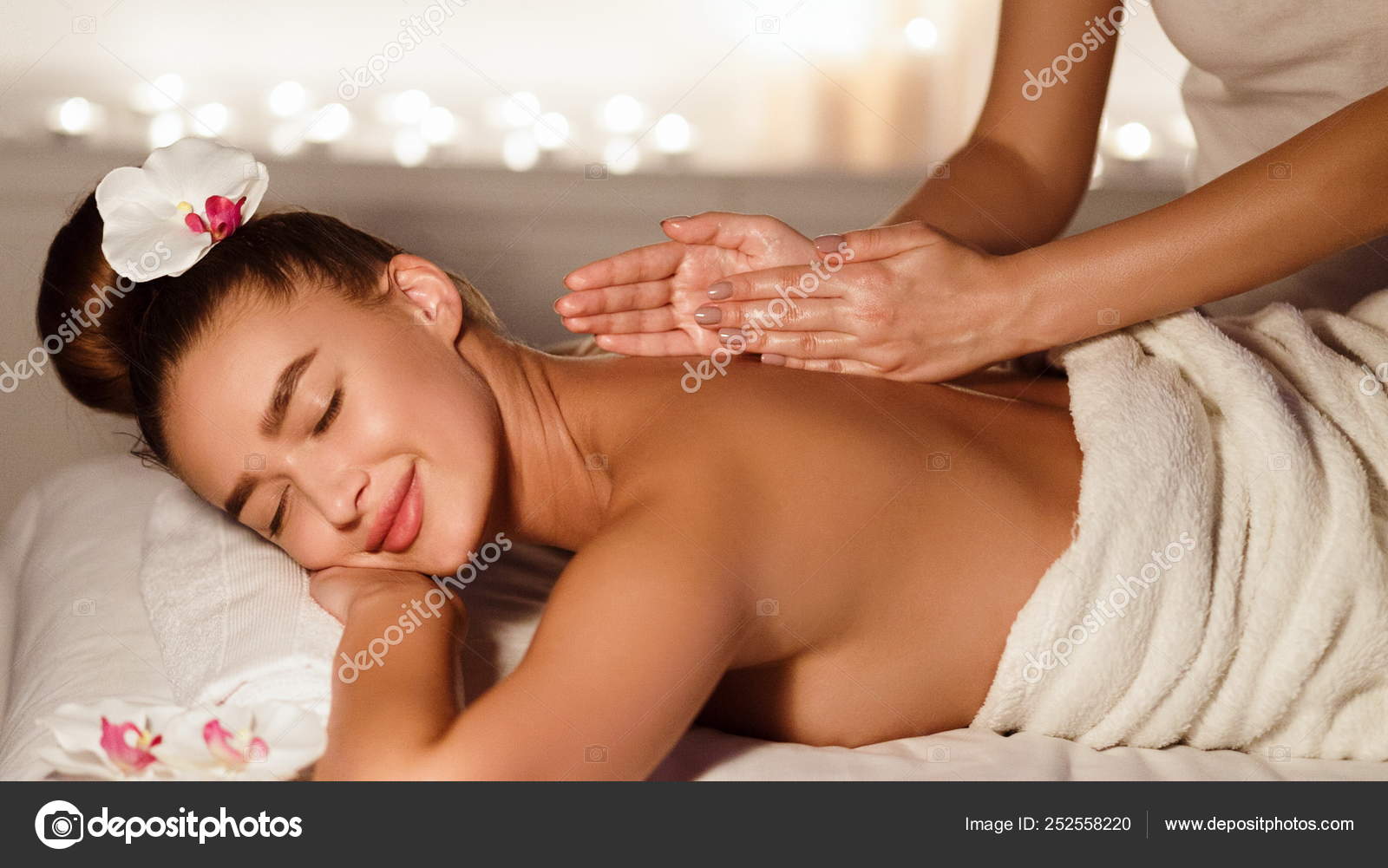 Body care. Relaxed woman enjoying back massage Stock Photo by