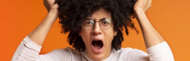 Crazy shouting man rending his bushy hair in stress clipart