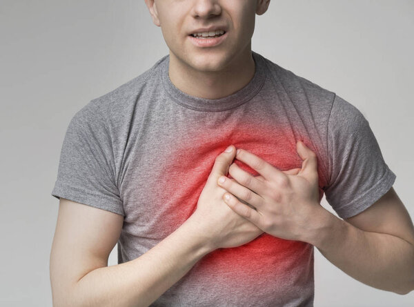 Young man having heart attack. healthcare concept