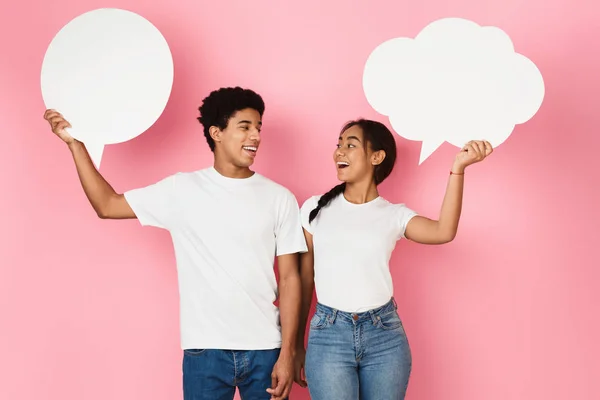 Adolescente casal com bolhas de fala no fundo rosa — Fotografia de Stock