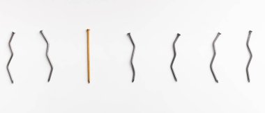 Bir altın tırnak arasında beyaz arka plan üzerinde bükülmüş çivi.