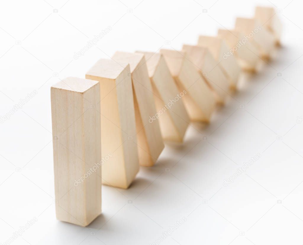 One wooden block stop other ones falling like dominoes