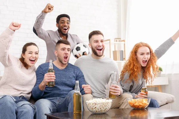 Happy friends watching football on tv and celebrating victory — Stock Photo, Image