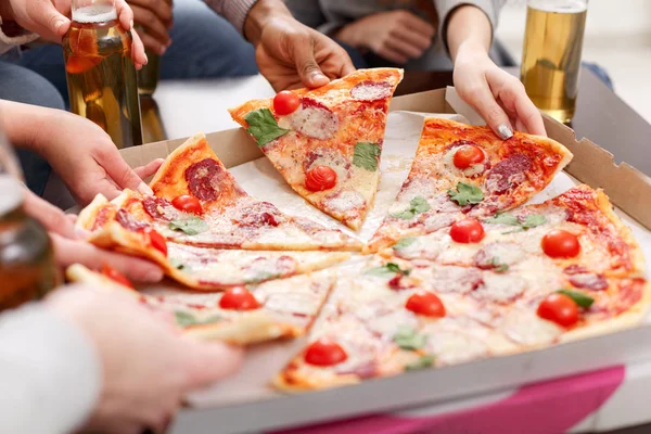 Friends eating delicious pizza at home party