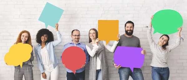 Group of diverse people holding colorful speech bubbles — Stock Photo, Image