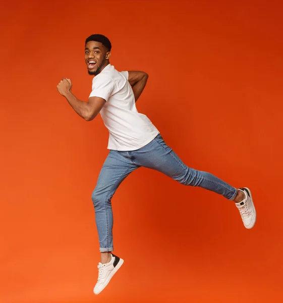 Emotional motivated african-american man running on air — Stock Photo, Image