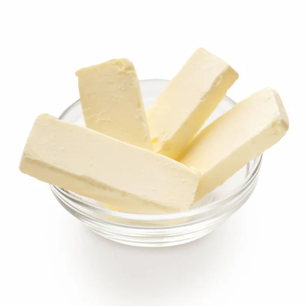 Bitar av smör i skål — Stockfoto