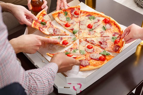 Lunch time. Friends eating delicious pizza, closeup