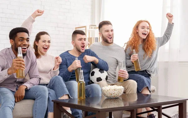 Happy football fans watching match on tv and celebrating victory — Stock Photo, Image