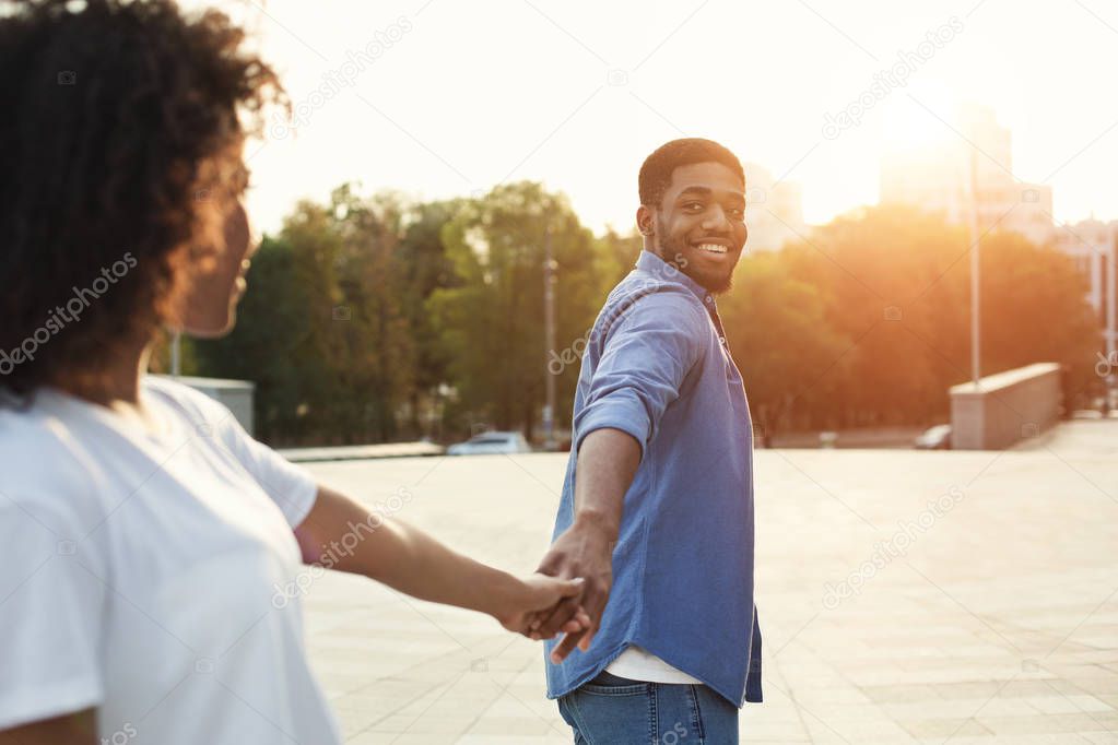 Follow me. Girlfriend following boyfriend holding hands